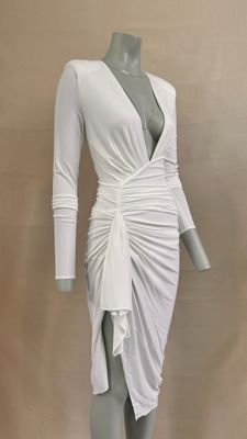 the mannequin is wearing a white dress with long sleeves
