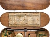 a wooden case with an old type of instrument inside of it