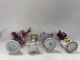 five figurines of people riding on a horse drawn carriage