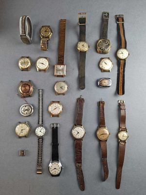 a lot of watches that are sitting on a table