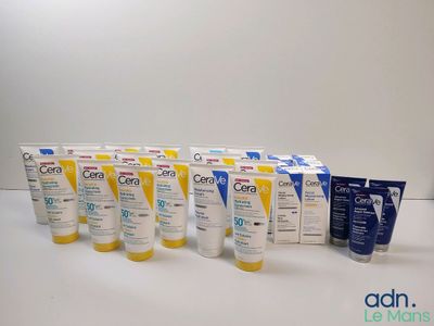 several tubes of sunscreen creams are lined up on a table