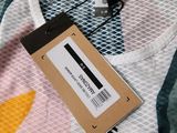 the back of a t - shirt with a tag attached to it