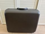 a black suitcase sitting on the floor in front of a door