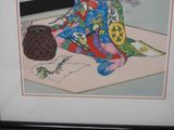 framed picture of a geisha woman sitting on the floor with a basket of flowers