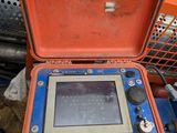 a blue and orange case with a monitor inside of it