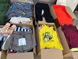 a box full of clothes that is sitting on the ground