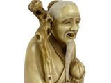 statue of an old man with a beard and a stick in his hand