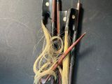 a vase with a bunch of different types of brushes in it