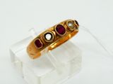 an image of a gold ring with garnets on it