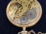 a gold pocket watch with a chain attached to it
