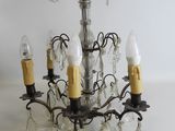 a chandelier that has five lights attached to it