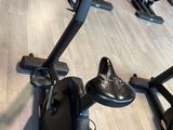 a row of stationary exercise bikes in a gym