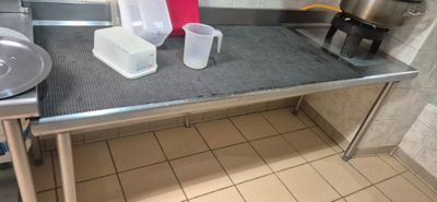 a kitchen with a sink, stove, and a counter top