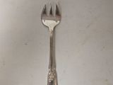 a fork and a spoon on a white surface