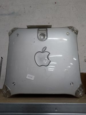 an apple laptop sitting on top of a cardboard box
