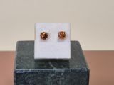 an image of a pair of earrings sitting on top of a marble block