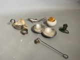 a lot of silver items that are on the table