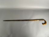 a long wooden handle that is attached to a metal rod