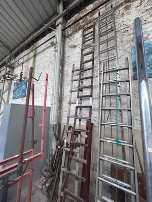 many ladders that are leaning against the wall