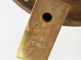 a gold plate with a small hole in it