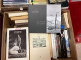 many books that are in a box on the floor