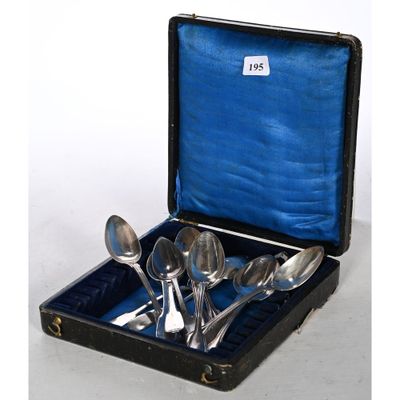 four spoons in a black case on a white surface