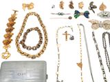 a lot of jewelry that is laying out on the table