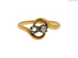 gros plan d'une bague en or ornée de deux diamants