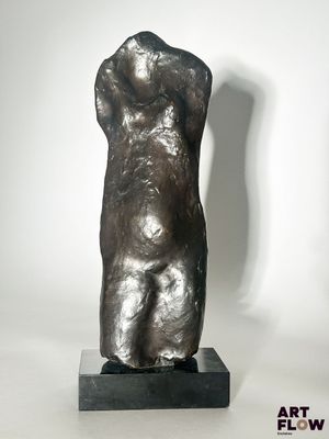 statue of a woman holding a baby in her arms on a black base