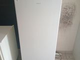a white refrigerator sitting in the corner of a room