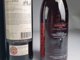 two bottles of wine sitting next to each other on a table