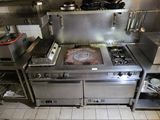 a kitchen with a stove, oven, and other appliances in it