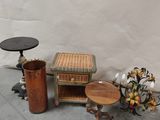 a small table with a basket on top of it next to a vase with flowers