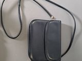 a black purse that is hanging on a wall