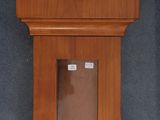 a wooden clock that is hanging on the wall