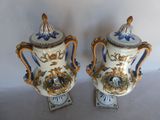 pair of blue and white vases with gold decoration on them