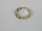 a close up of a gold ring on a white surface