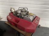 a red fire hydrant sitting on top of a wooden table