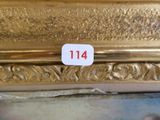 a gold plate with a number on it and a sticker on it