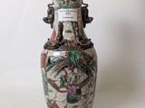 a vase that has a picture of a dragon on it