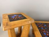 two wooden tables with blue and orange designs on them