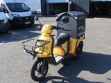 a yellow scooter that is parked in a parking lot