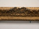 an image of a gold frame with a picture of a bird on it