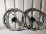 une paire de roues à rayons posées sur une surface blanche