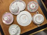 a table that has a bunch of plates and cups on it