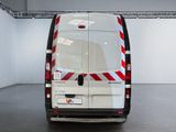 a white van with red and white stripes parked in a garage