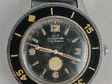 an image of a wrist watch with a black face and yellow hands