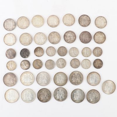 an assortment of old coins on a white surface