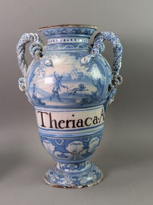 a blue and white vase with a rope around it