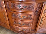 a wooden cabinet with a marble top on a tile floor